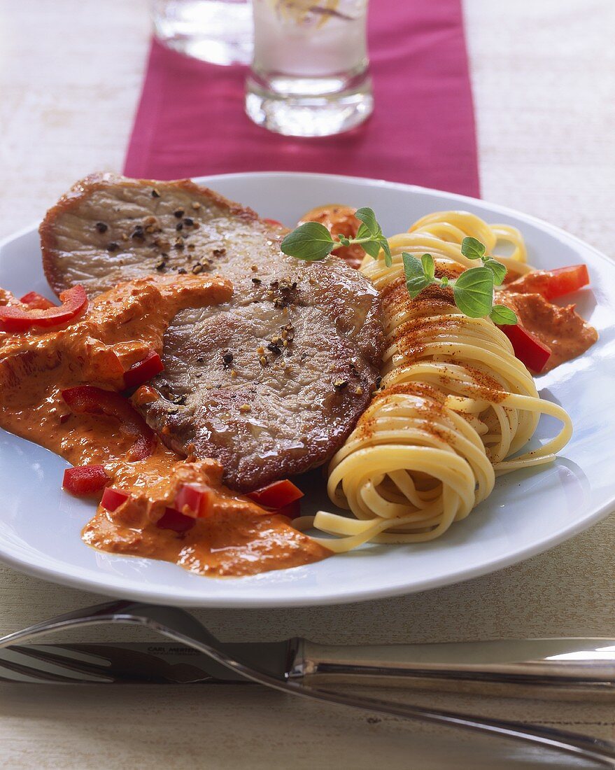 Pork steak with pepper, pepper sauce and noodles