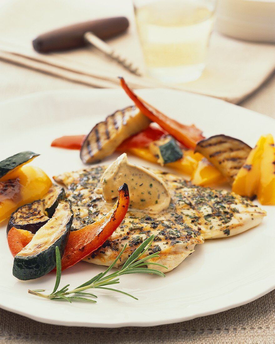Barbecued chicken breast with herb butter and vegetables