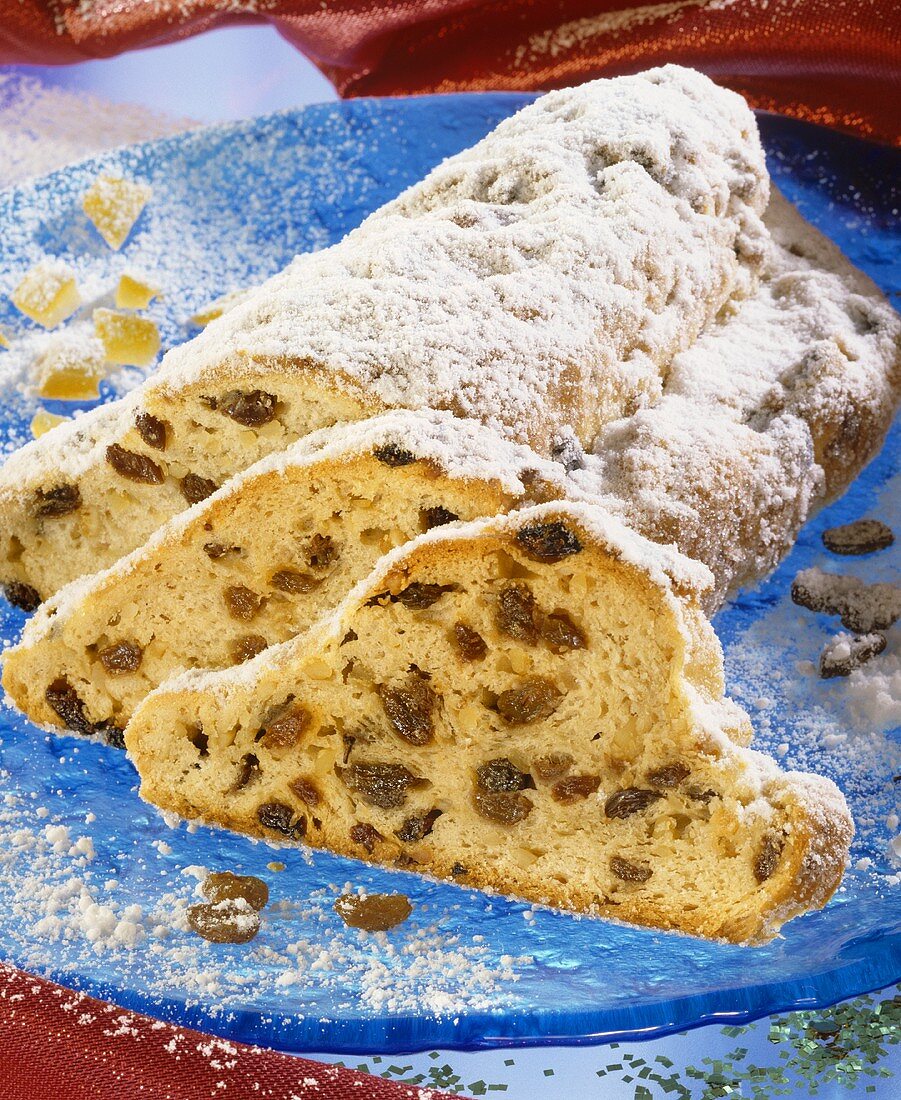 Christmas stollen packed with raisins, a piece cut