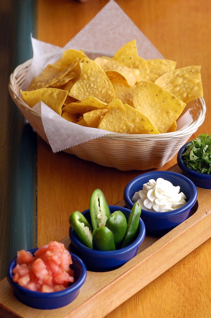 Nachos (corn chips) and a few bowls of sauce and snacks