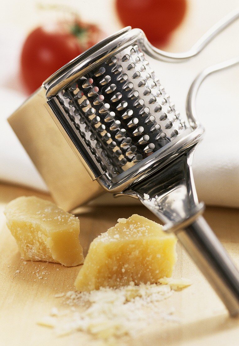 Whole and grated Parmesan cheese, grater
