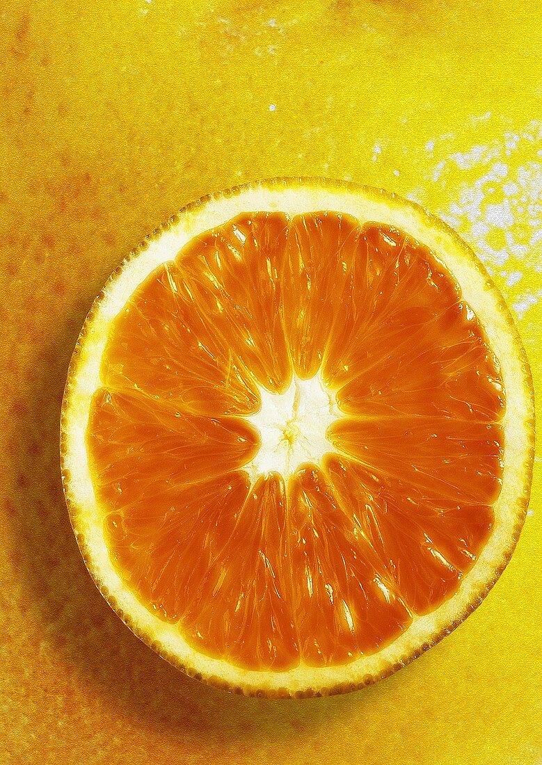 Slice of orange, background: orange peel