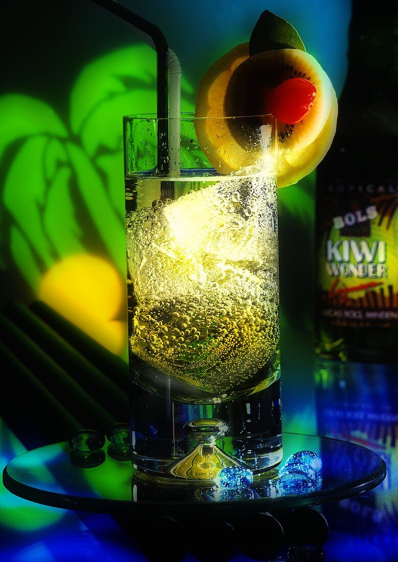 Sparkling kiwi fruit and lemon drink in long drink glass