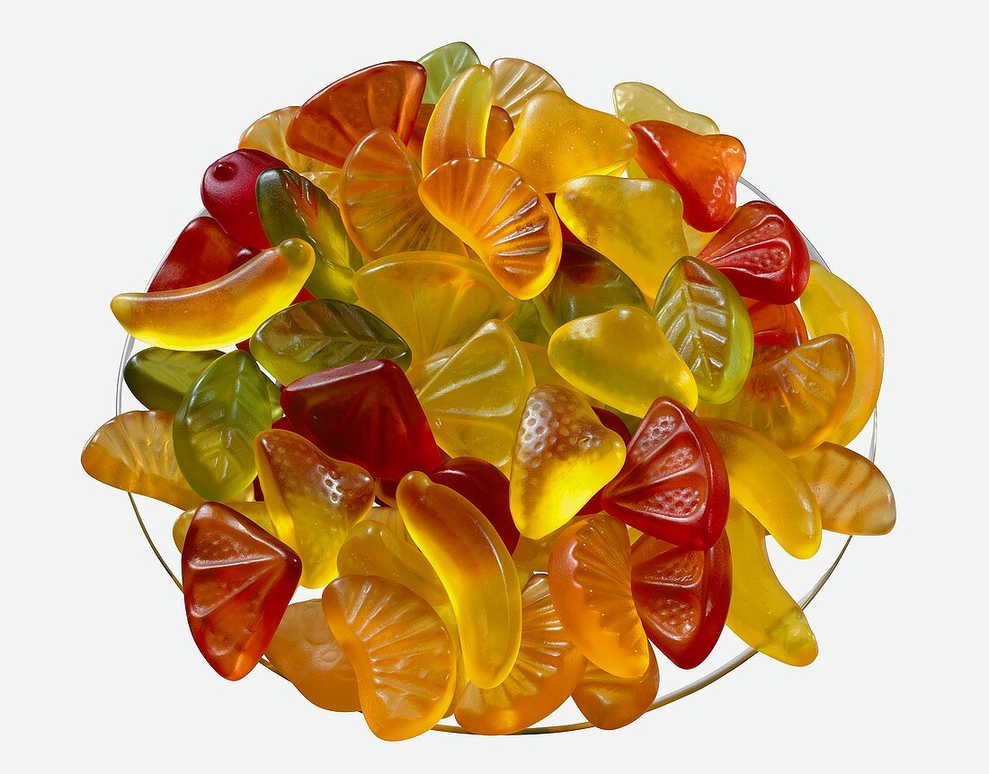 Bowl of wine gums on white background