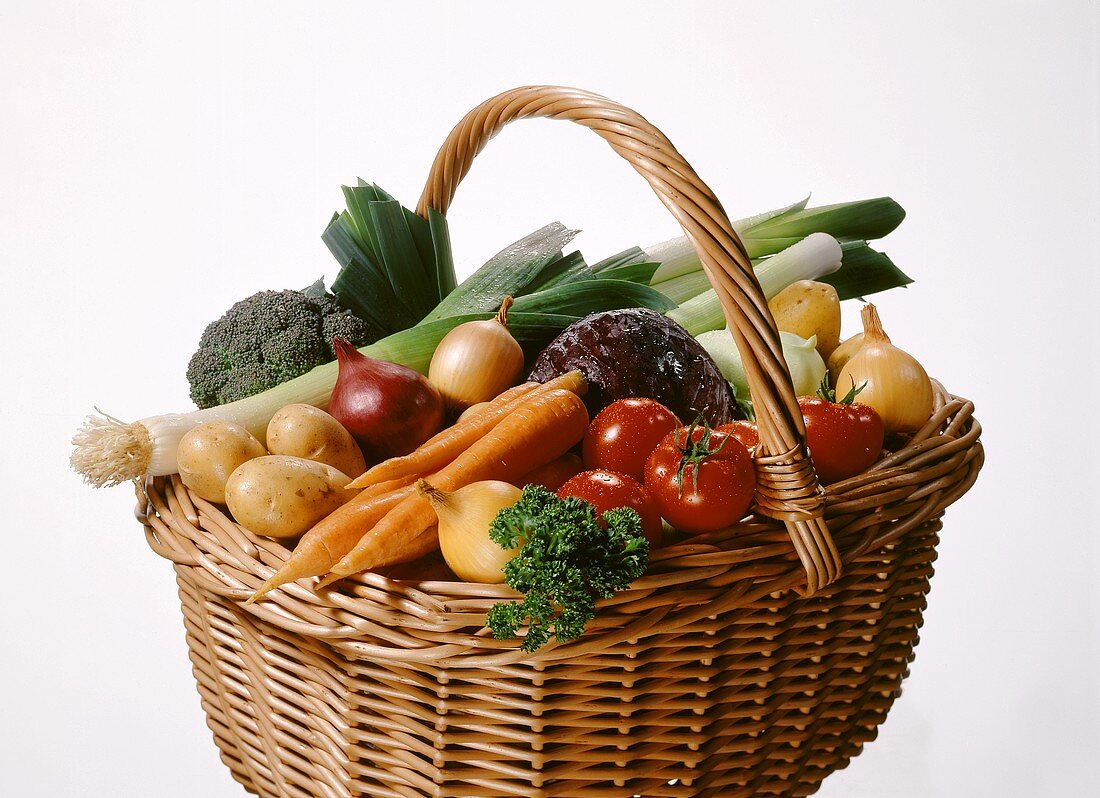 Raffia basket of assorted vegetables and parsley