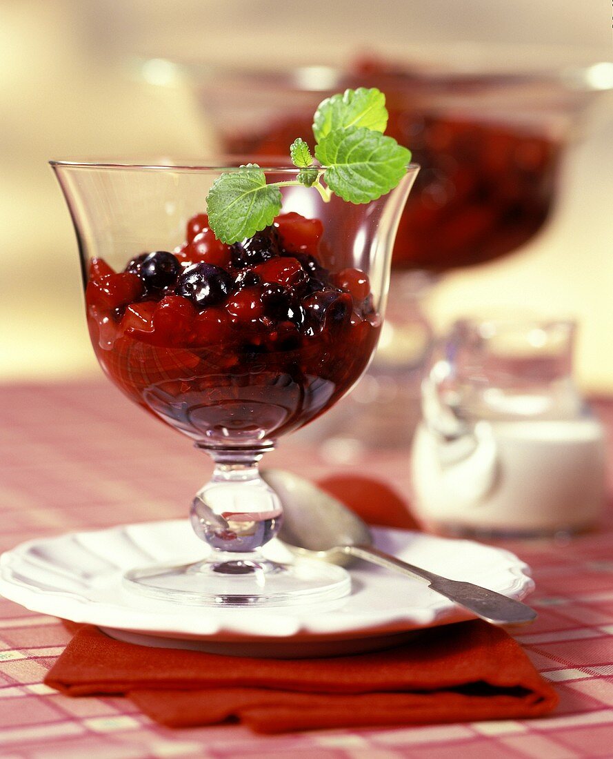 Red fruit compote in a glass bowl