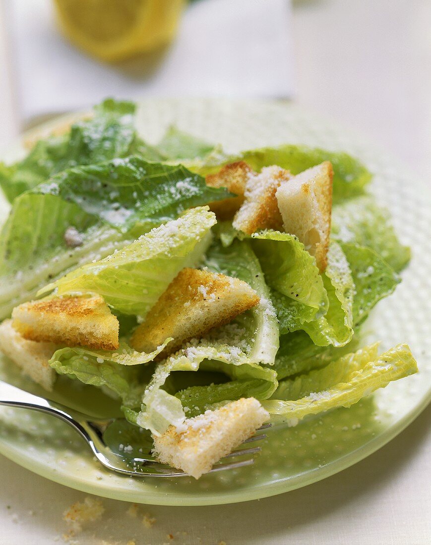 Caesar salad with croutons and grated Parmesan