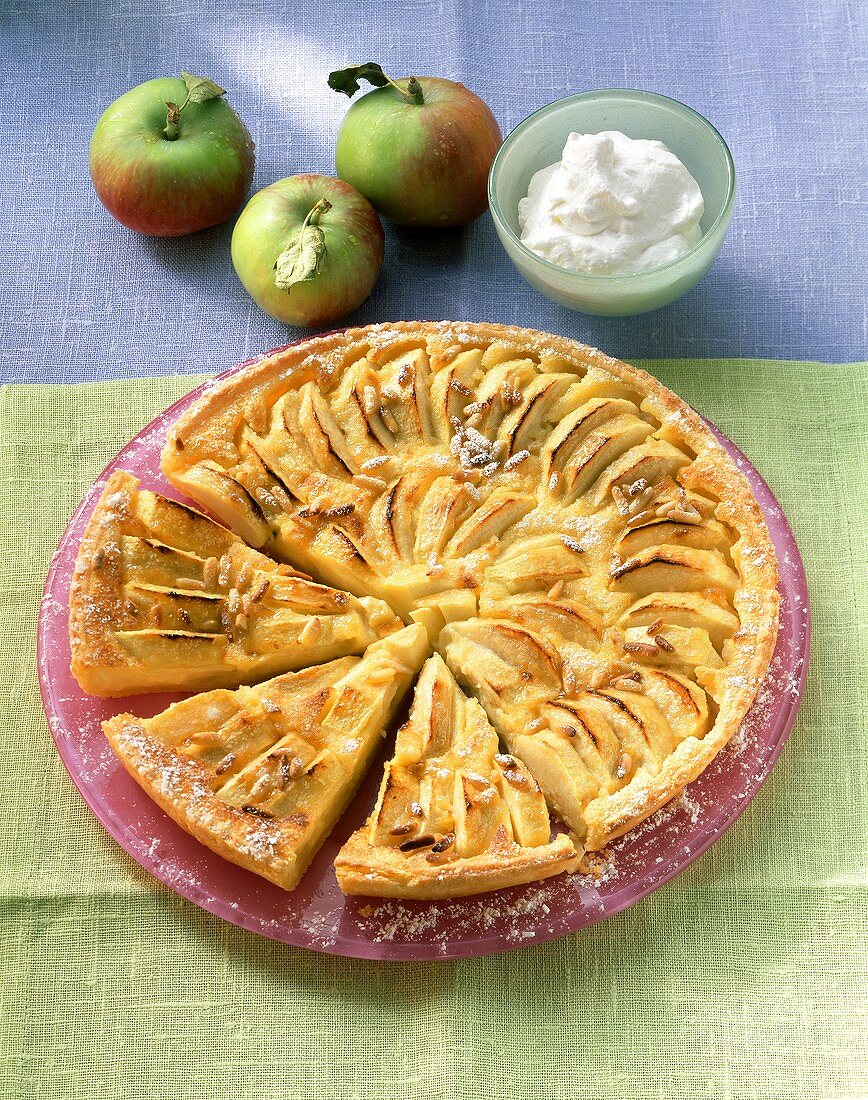 Apple tart with pine nuts, a piece cut
