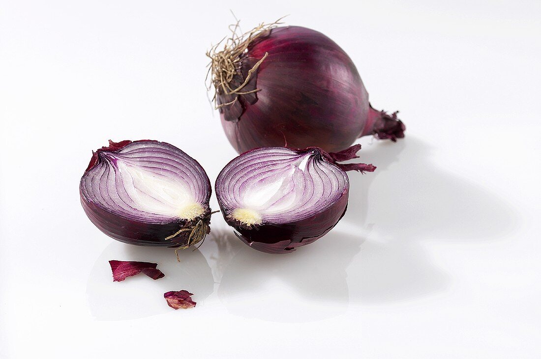 One whole and one halved red onion