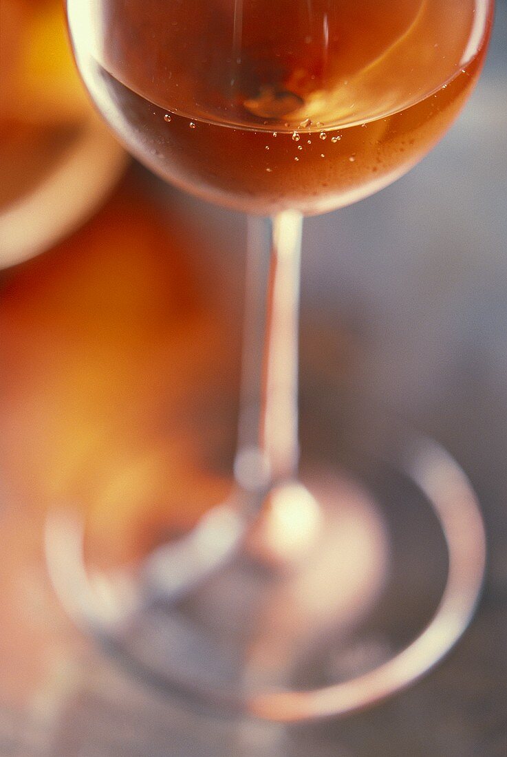 A half-filled rosé glass