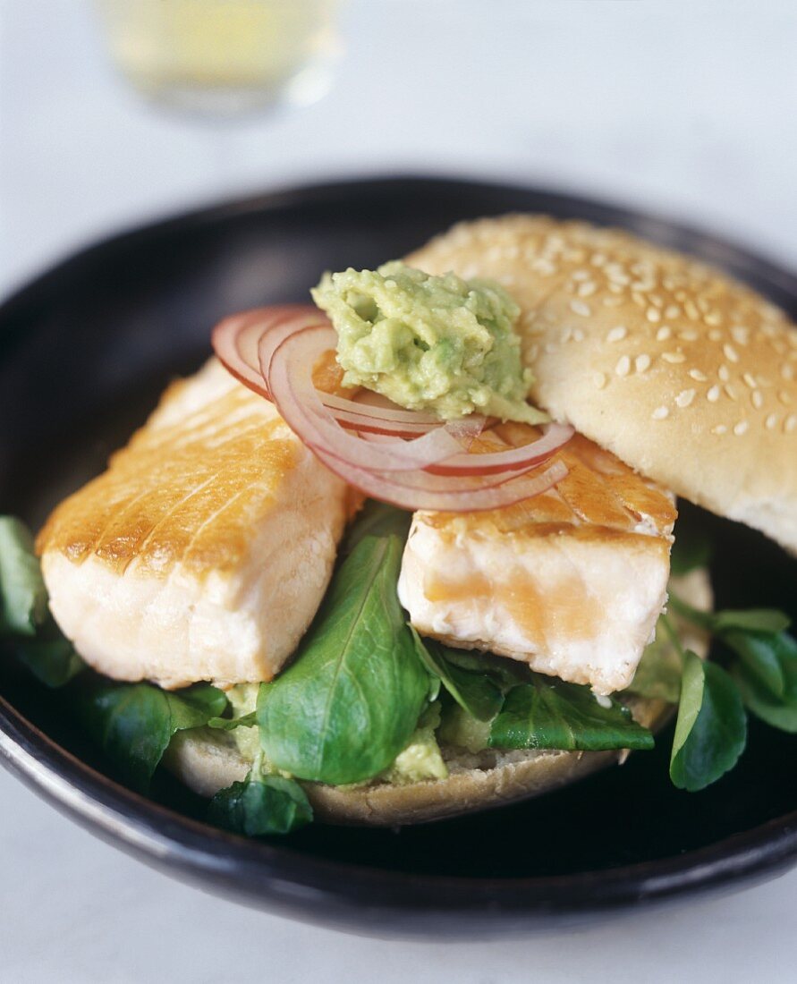 Salmon burger with guacamole and lettuce