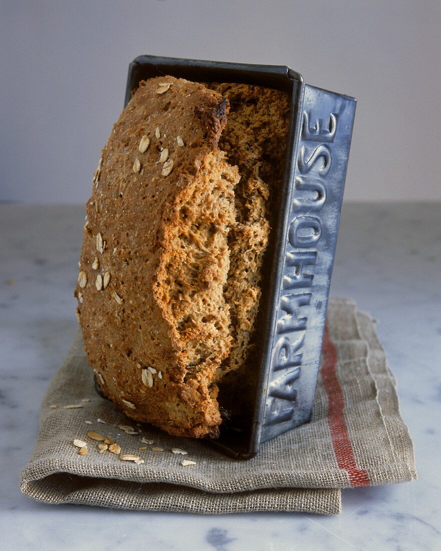 Wholewheat bread with oat flakes in loaf tin