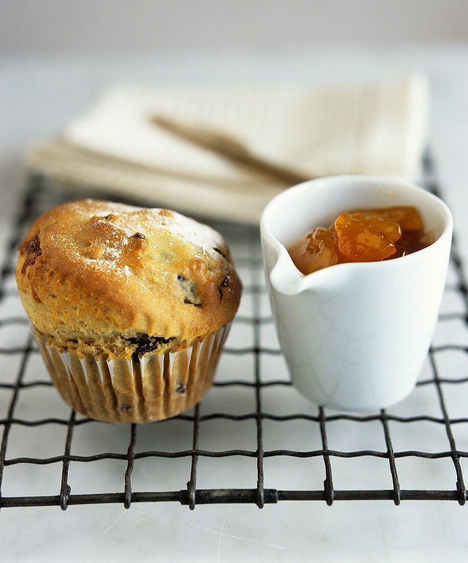 Fruit muffin and a pot of apricot jam