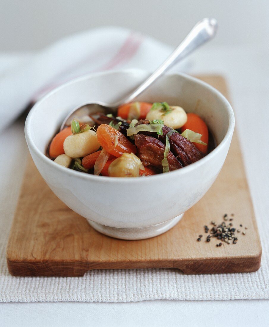 Crispy roast duck with dried apricots on vegetables