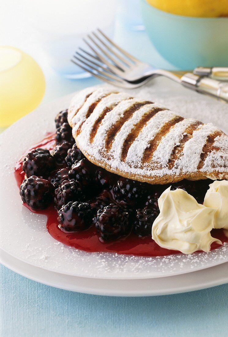 Sweet souffle omelette with icing sugar and berry filling