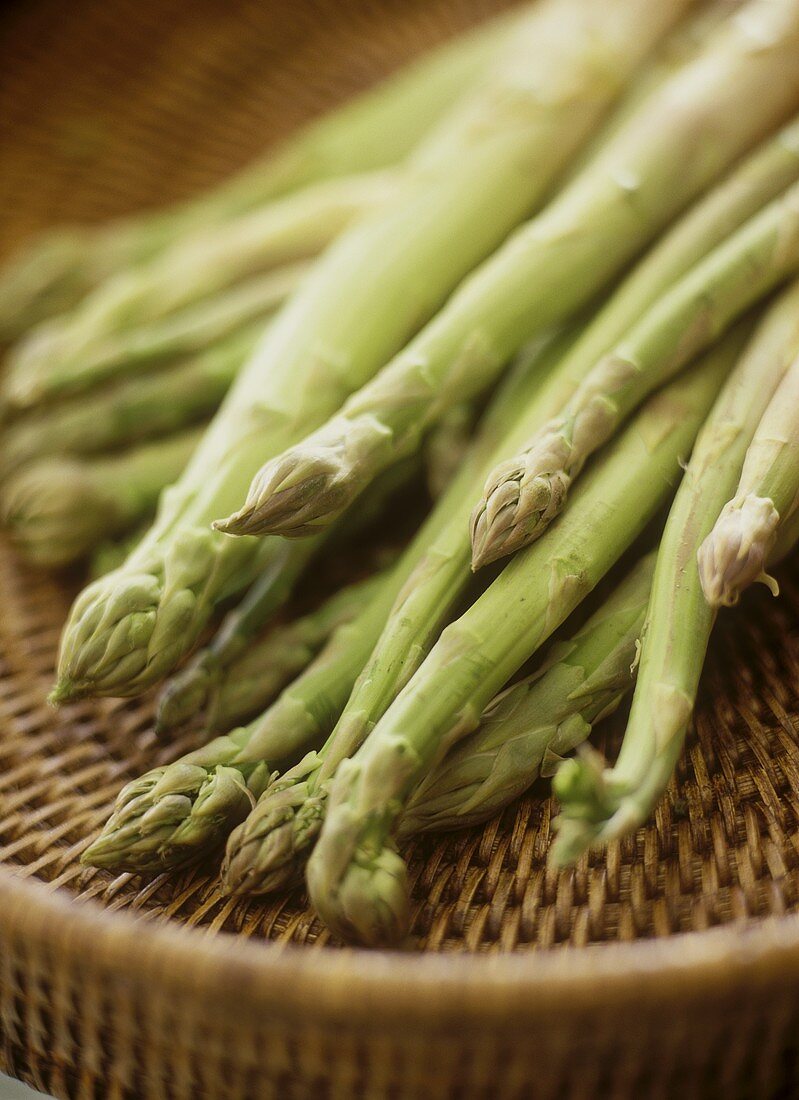 Green asparagus on a wicker tray