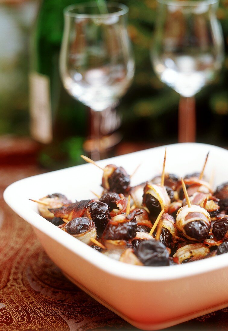 Baked prunes wrapped in bacon