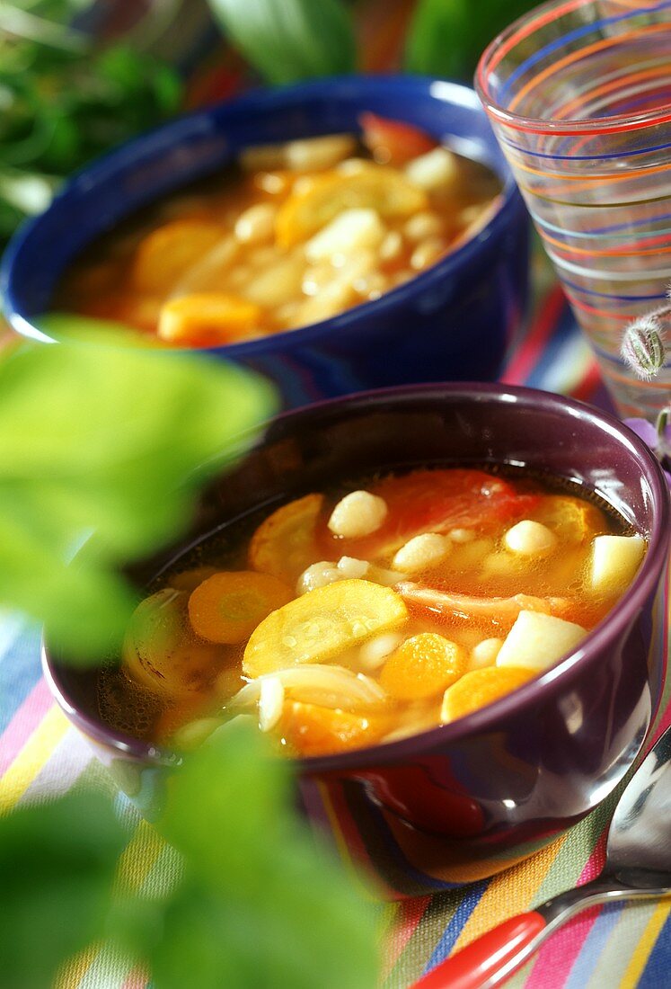 Vegetable soup with tomatoes, root vegetables and beans