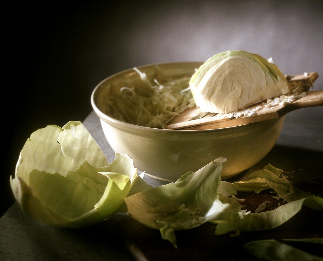 Still life with piece of white cabbage and grated cabbage
