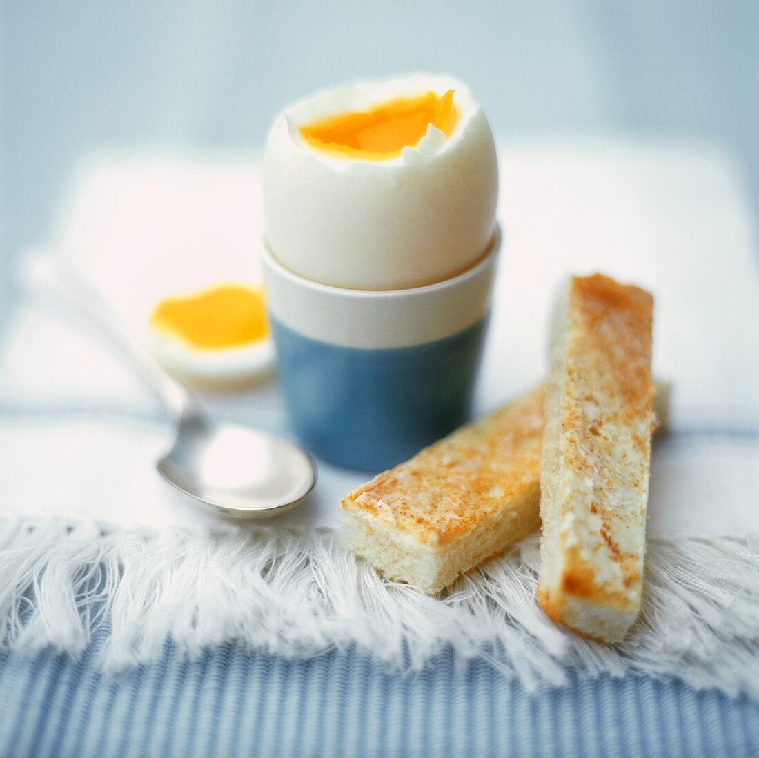 Boiled breakfast egg with buttered toast soldiers