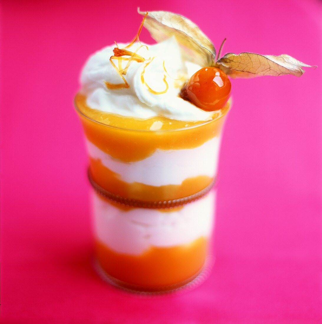 Layered physalis dessert with quark and cream topping