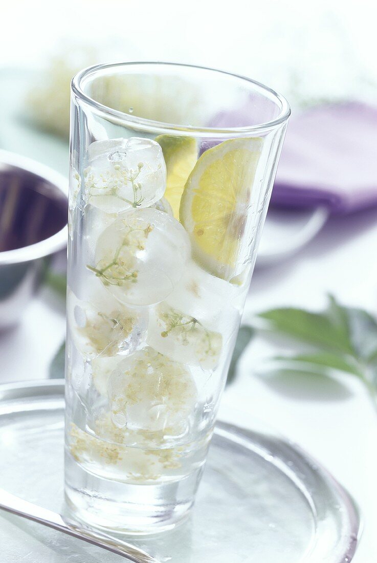 Elderflower ice cubes in a glass