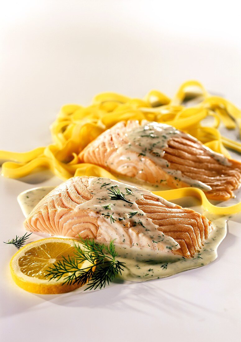 Salmon fillets with ribbon pasta and cream and dill sauce