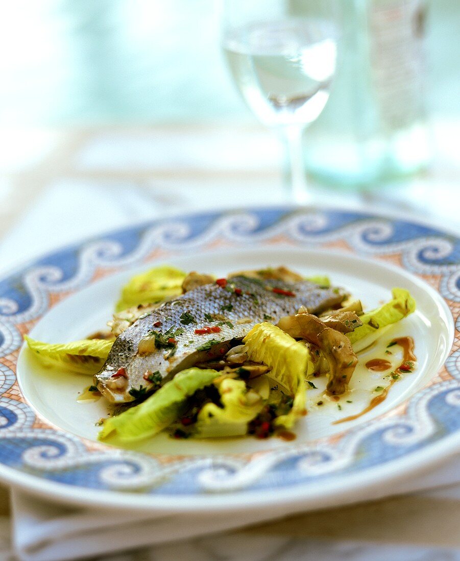 Marinated sea bass with artichokes and lettuce