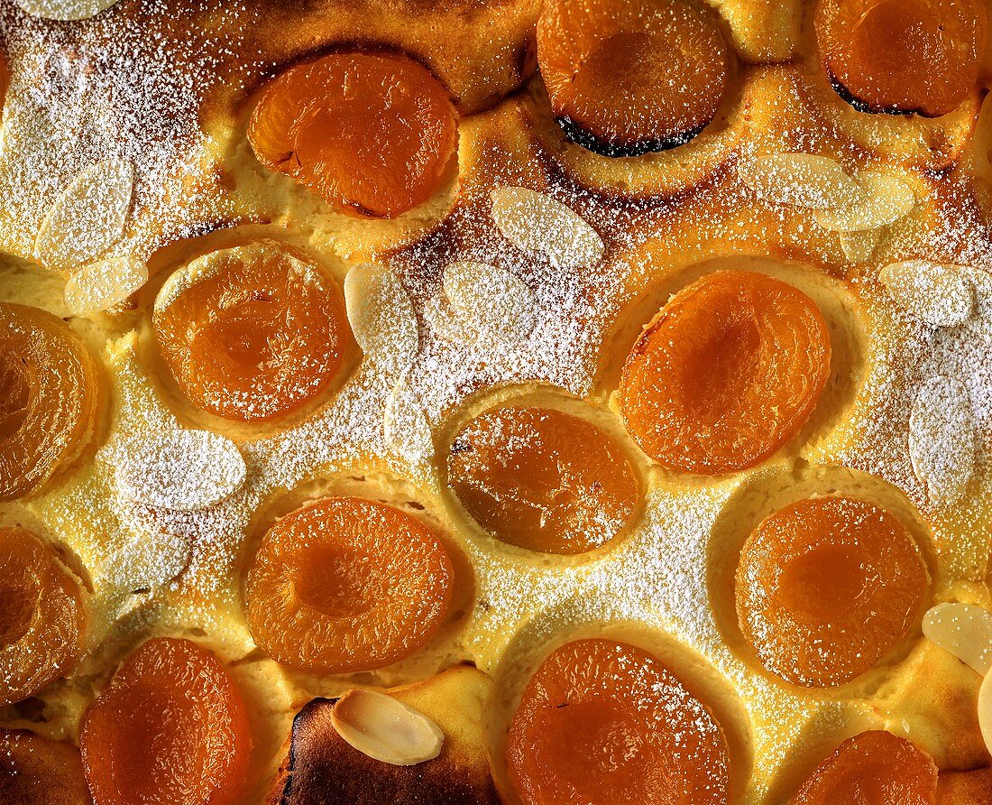 Sweet quark and apricot pudding with almonds (close-up)