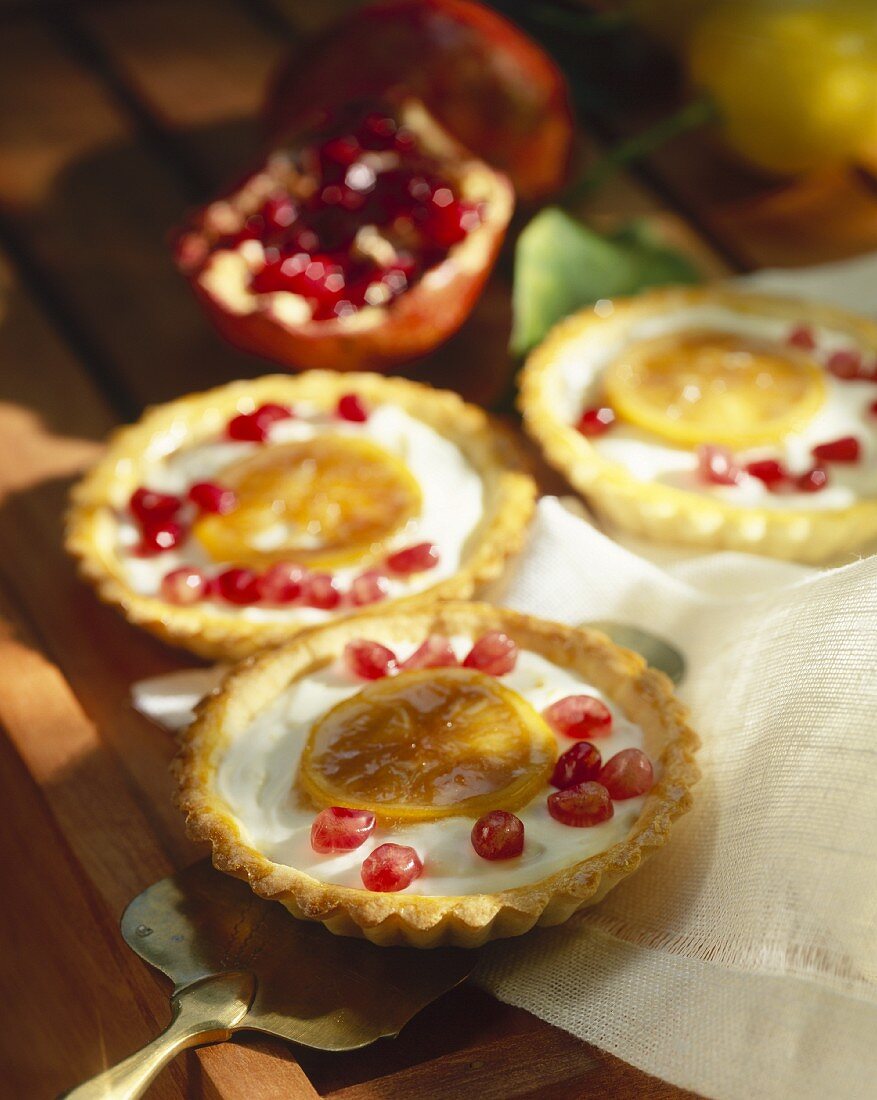 Tartlets with orange cream and pomegranate seeds
