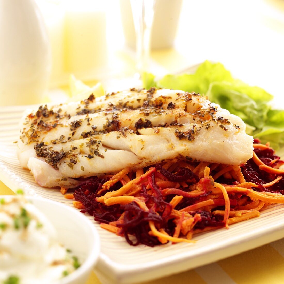 Fish fillet on beetroot and carrot salad