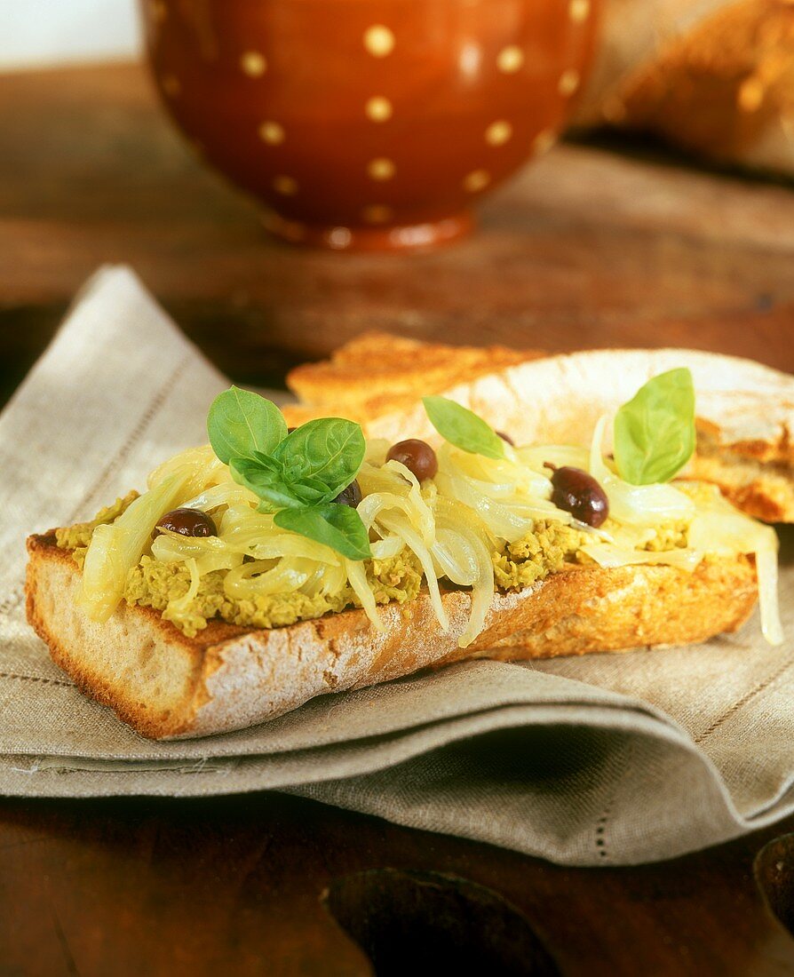 Baguette with olive cream, olives and onions