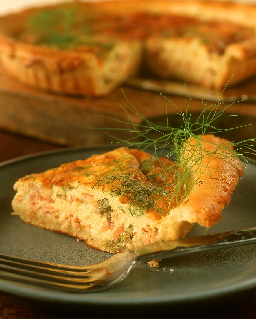 A piece of mini-quiche with smoked salmon and dill