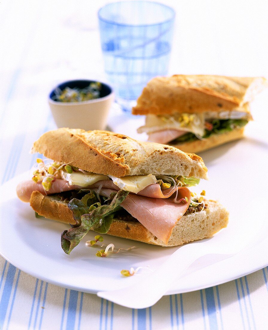 Baguette sandwich with Brie, boiled ham and sprouts