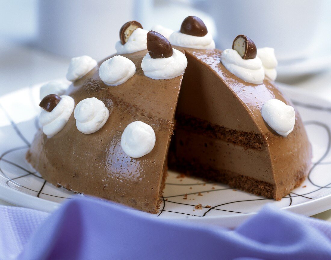 Nutella dome cake decorated with cream rosettes & chocolates