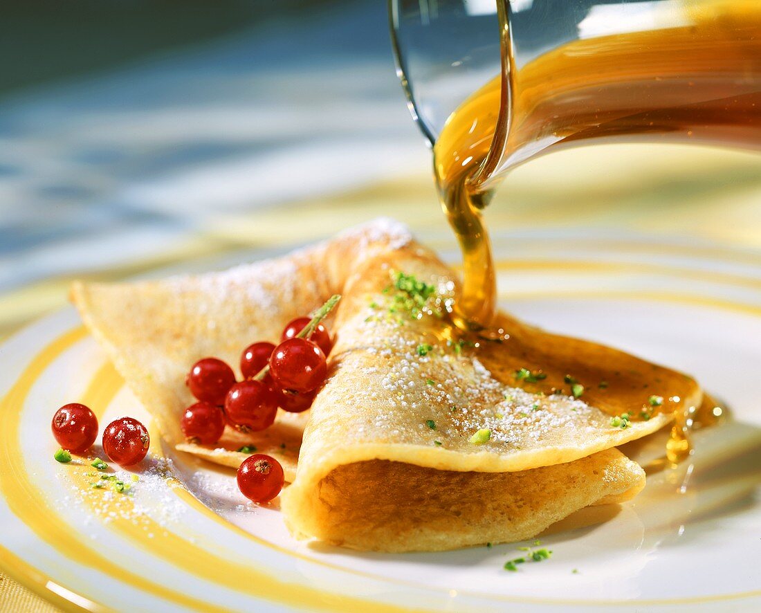 Pancakes with redcurrants and maple syrup