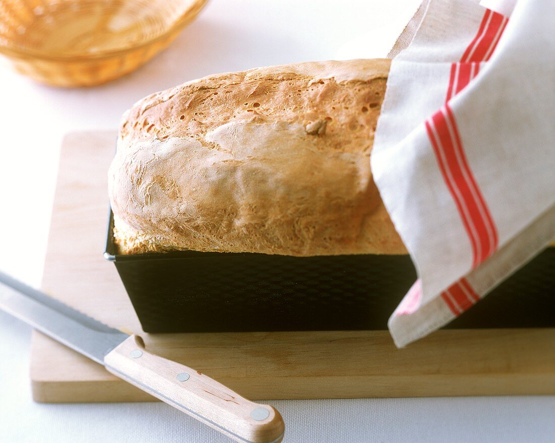 Home-made white sandwich loaf in a loaf tin