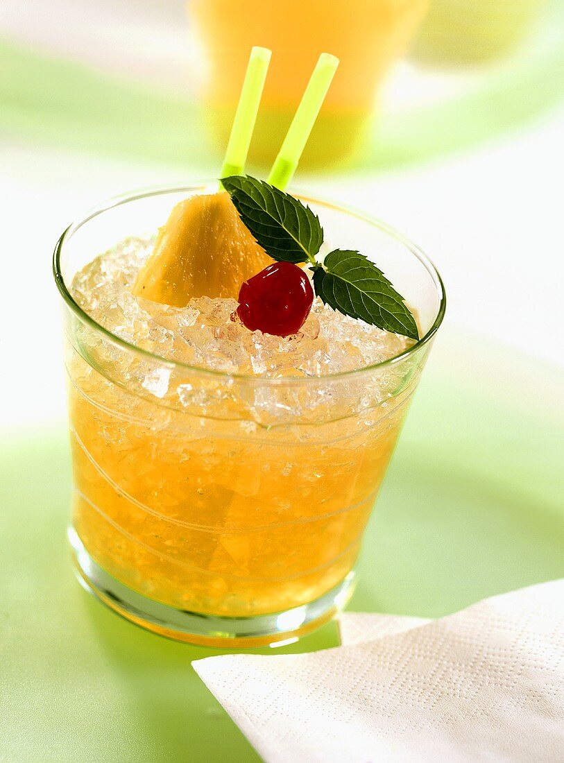 Mai Tai in glass, garnished with pineapple, mint, cherry