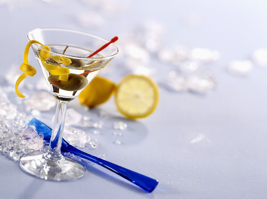 Glass of Martini with olive and lemon peel