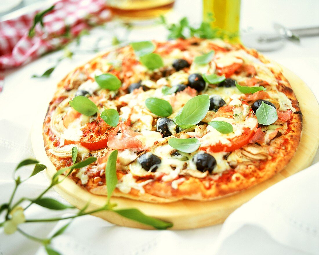 Pizza with vegetables, ham and cheese