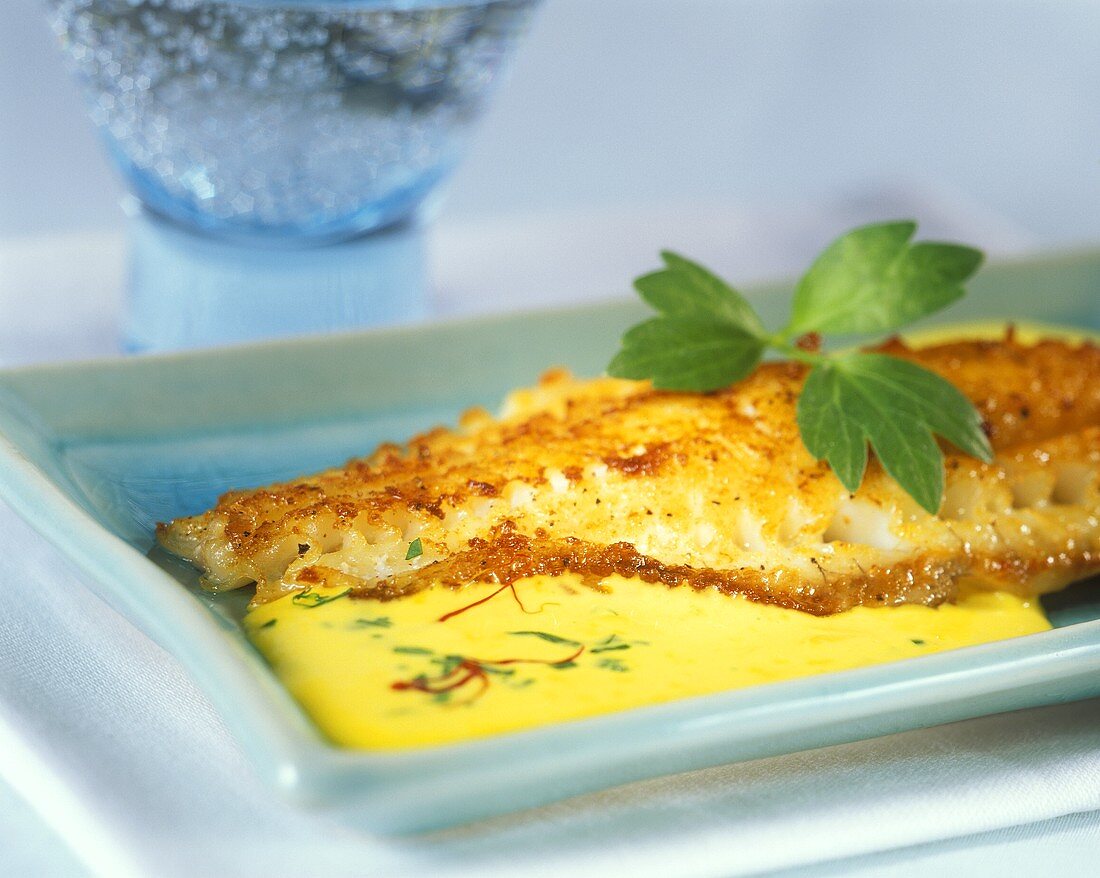Fried red snapper in saffron cream sauce with lovage