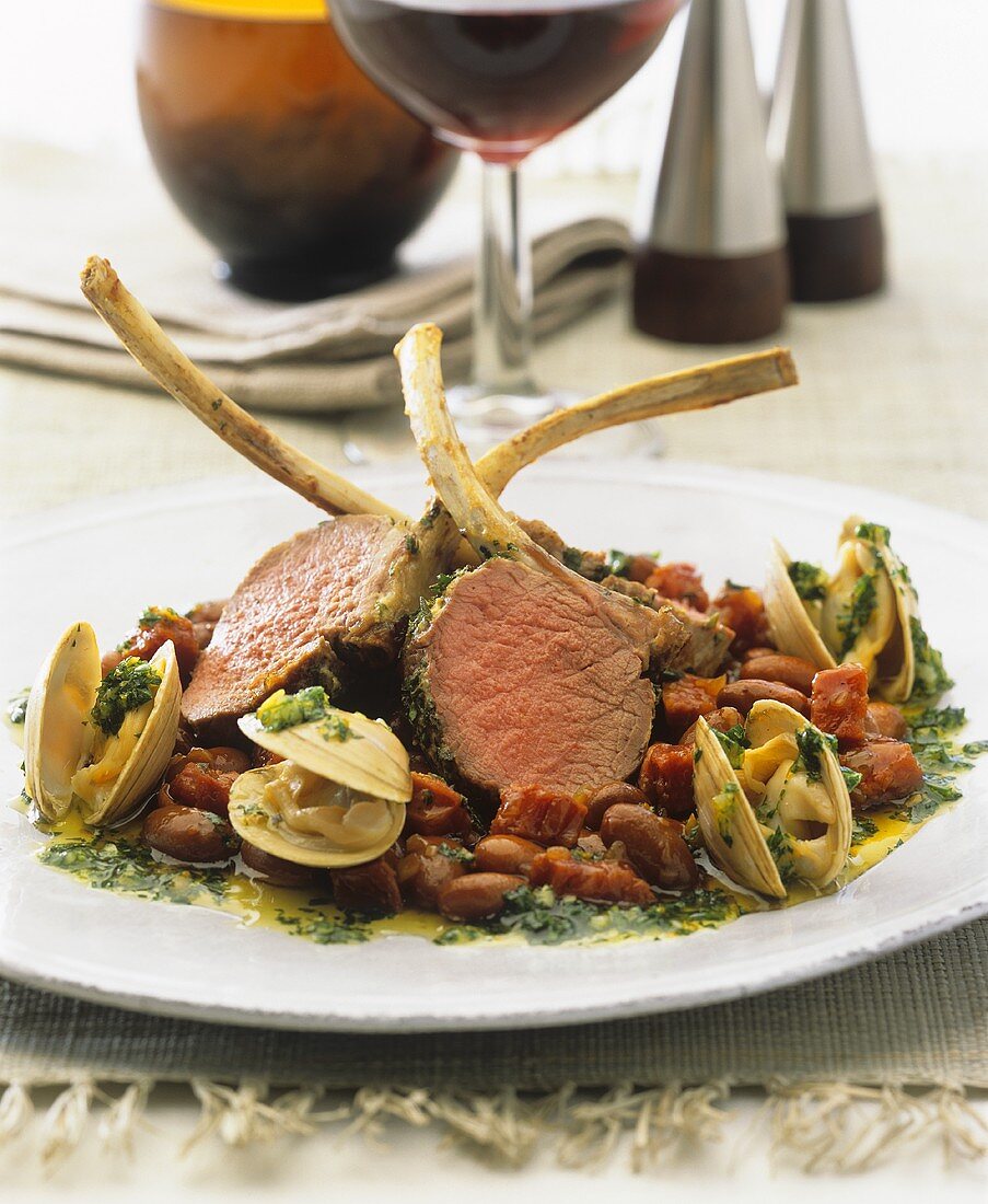 Slices of rack of lamb and mussels on beans