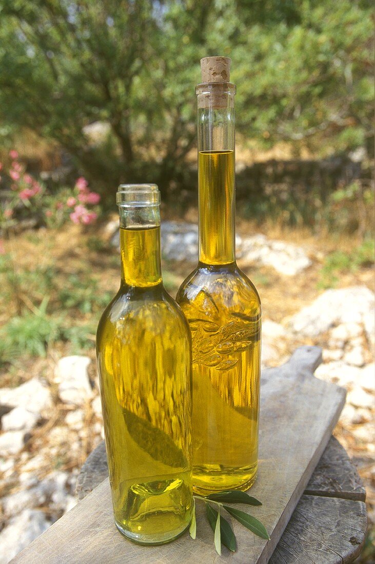 Two bottles of olive oil (outdoor shot)