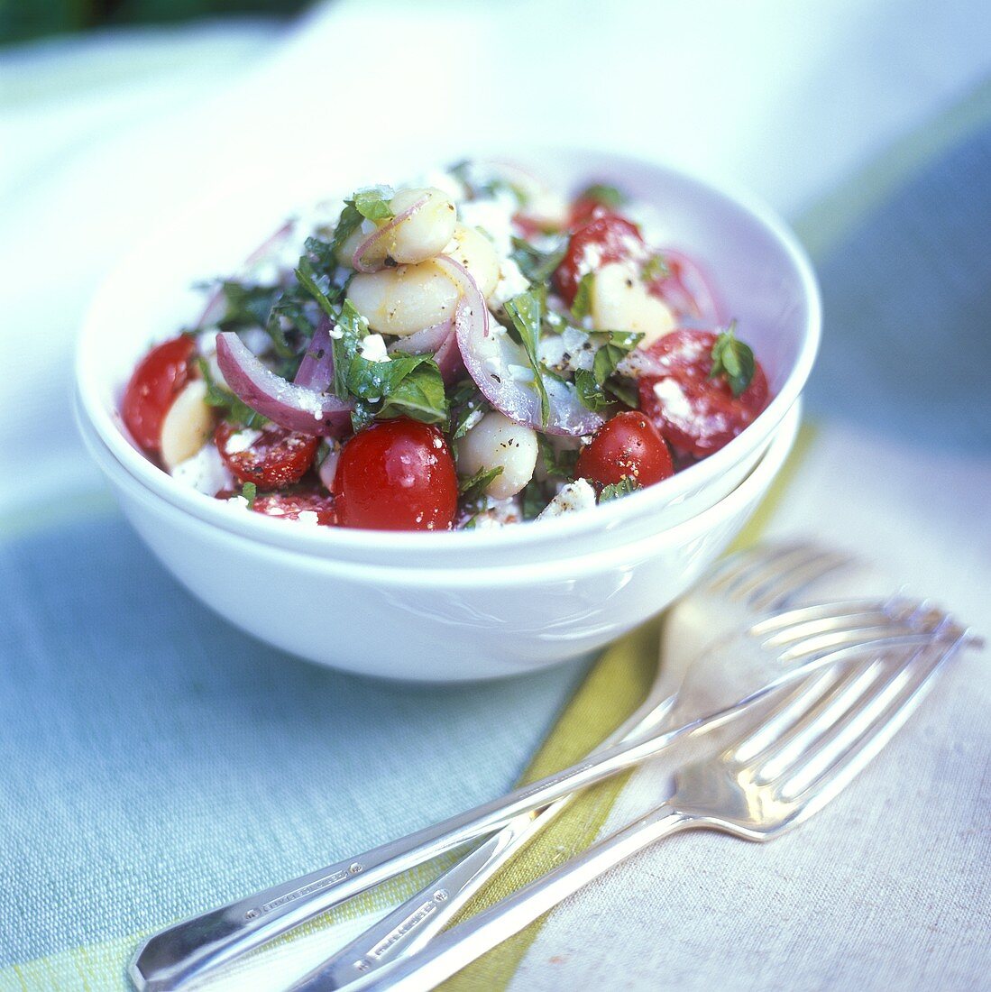 Bean and tomato salad with sheep's cheese and basil