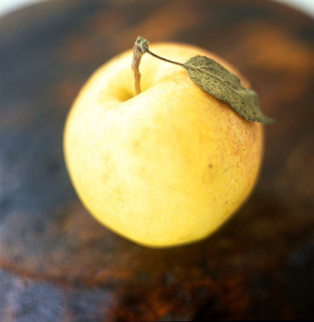 Golden Delicious apple with leaf