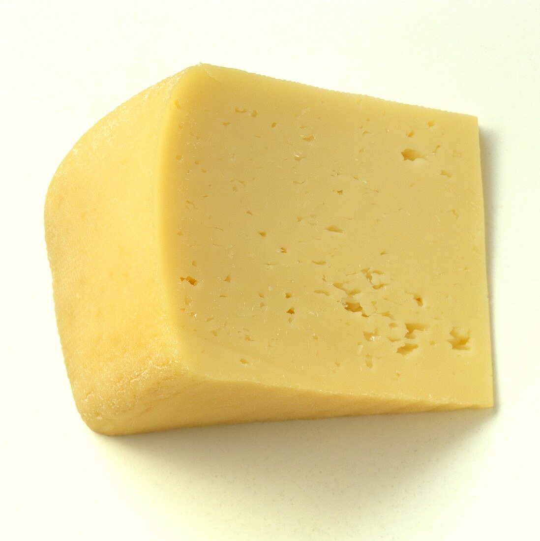 A triangle of Bierkäse (beer cheese) on white background