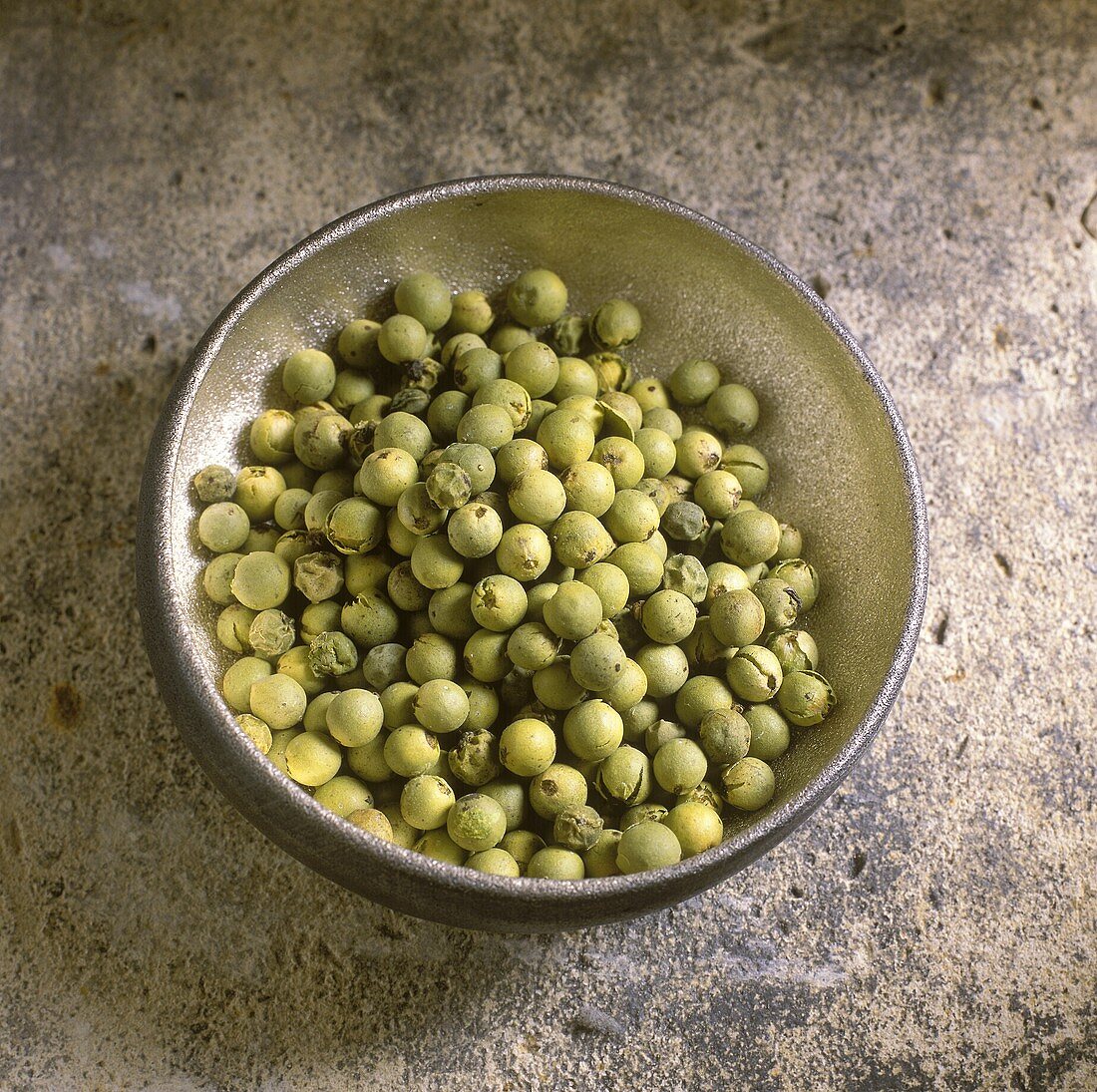 Green peppercorns in an iron bowl