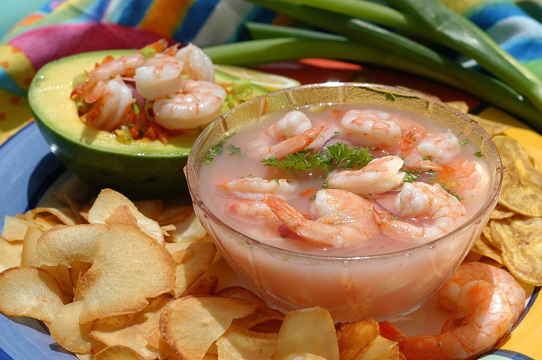 Shrimps in a glass bowl and avocado stuffed with shrimps
