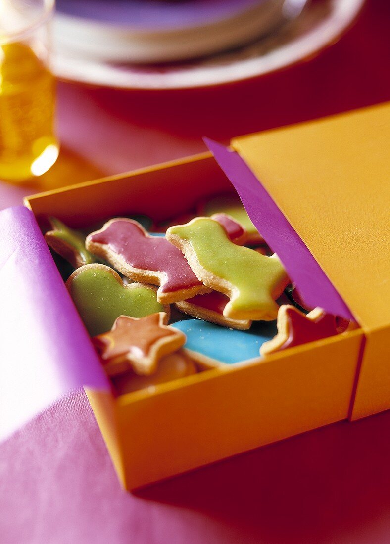 Colourful iced butter biscuits in a gift box