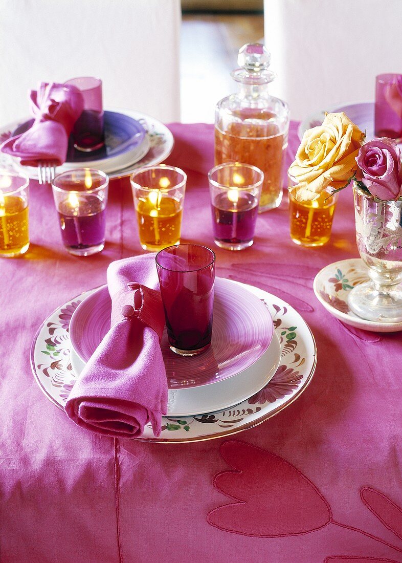 Festive table in violet and orange with gel candles